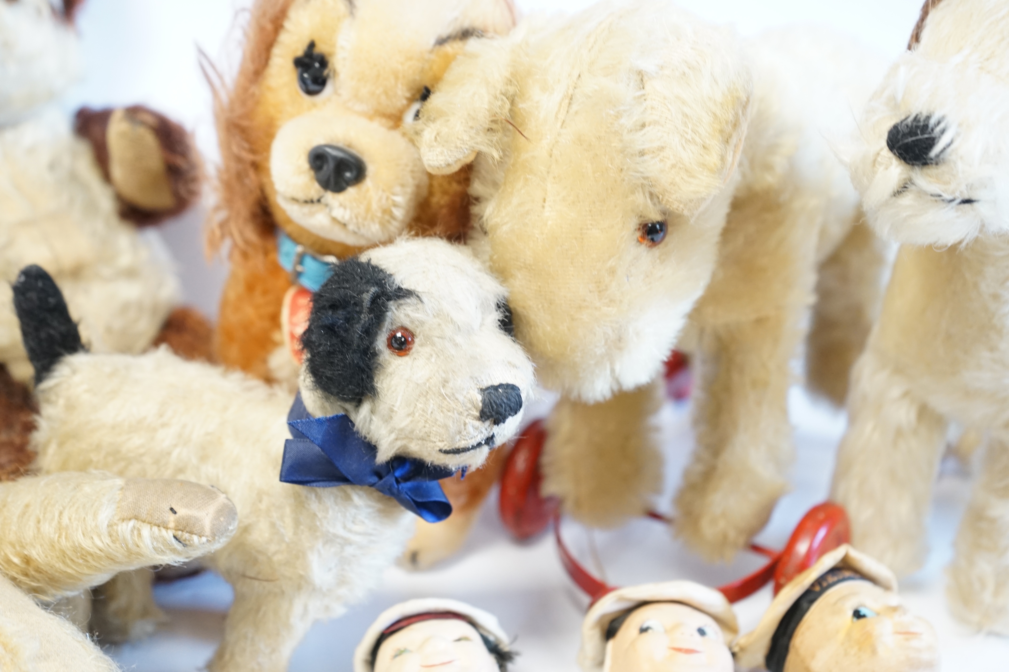 A Schuco Bigo Bello dog 'Lady', with collar and label, three Norah Wellings sailor dolls, four other toys, a 1930's Merrythought Teddy, with button and label, some hair loss, and a Merrythought dog on wheels (10). Condit